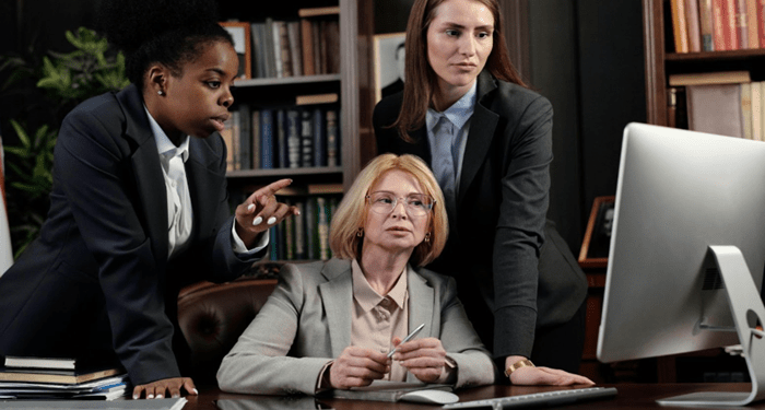 Senior attorneys reviewing online search performance together, illustrating how law firm SEO supports visibility, trust, and client decision-making in modern legal practices.